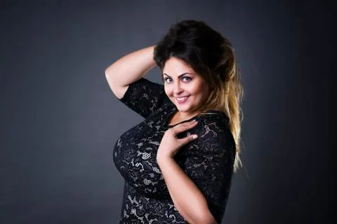 Young beautiful plus size model in black lace dres, xxl woman portrait Stock Photos