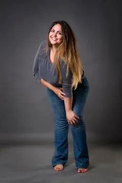 Young beautiful plus size model in blue jeans, xxl woman Stock Photos