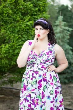 Young beautiful plus size model in dress outdoors Stock Photos