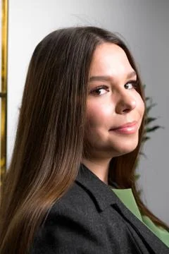 Young beautiful plus size model in jacket indoors, confident woman in the office Stock Photos