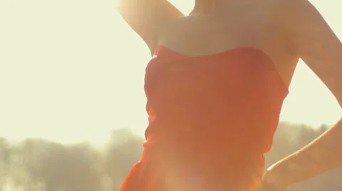 Young beautiful professional model posing on camera in a red long dress Stock Footage 61727727
