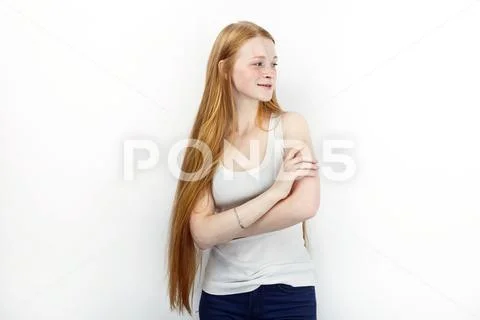 Young beautiful redhead beginner model woman in white t-shirt blue jeans prac Stock Photos