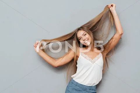 Young beautiful smiling girl with long hair posing Stock Photos