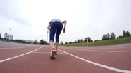 A Young Beautiful Sport Woman Starts Running At The City Athletics Track During Stock Footage