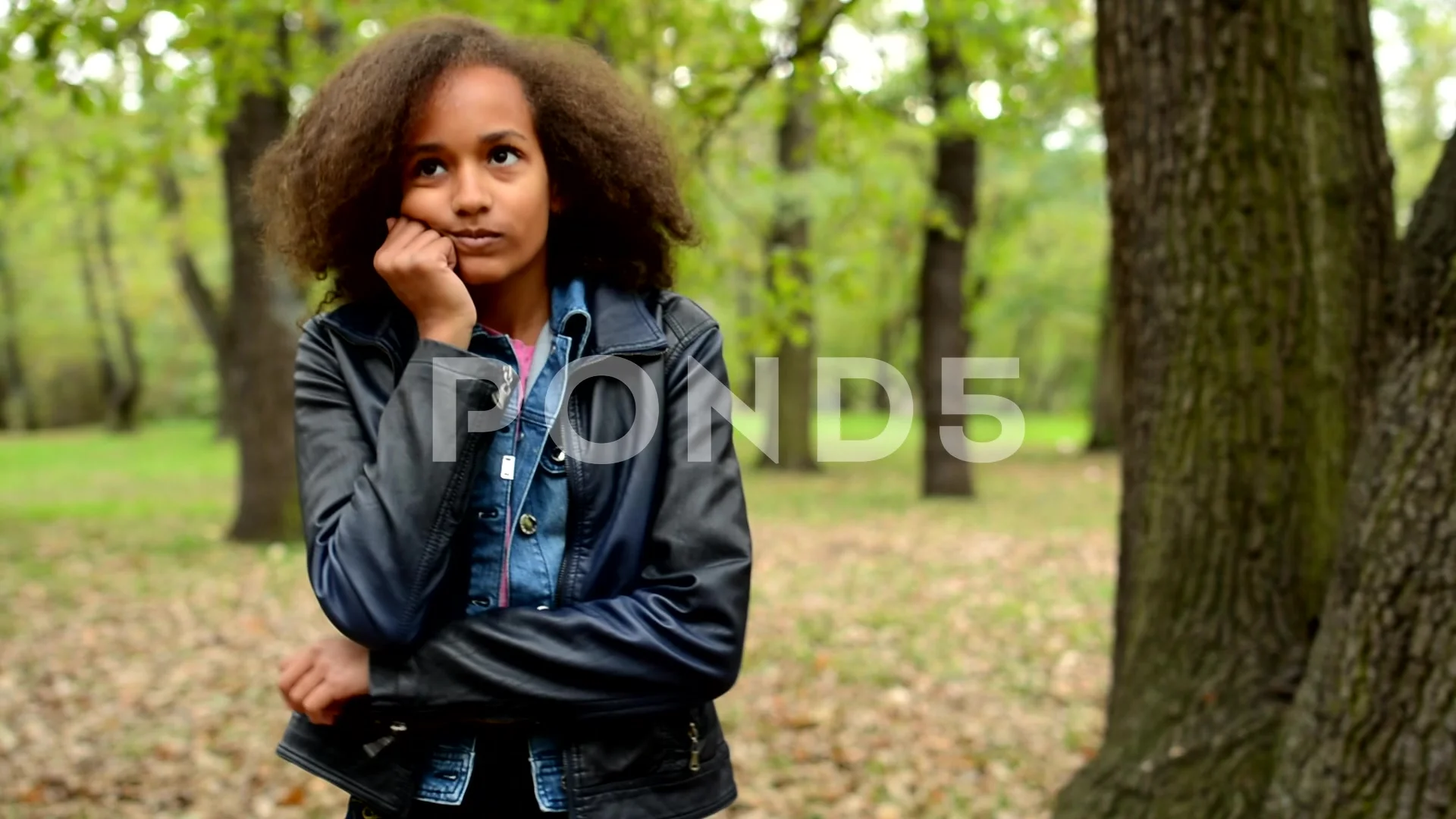 young beautiful sullen african girl is bored in the park