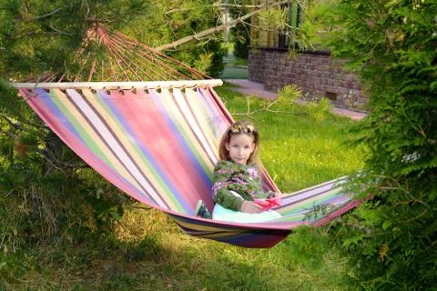 Young beautiful teen gir in hammock enjoys the sunny morning Stock Photos