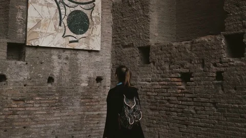 Young beautiful tourist is in Palatine Hill in Rome, Italy, considering an Stock Footage