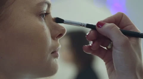 Young beautiful  woman applying make-up by make-up artist. brush Painting Stock Footage 59597352