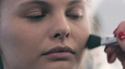 Young beautiful  woman applying make-up by make-up artist. brush Painting Stock Footage 59598565