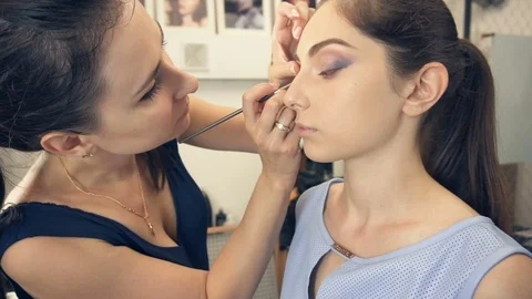 Young beautiful woman applying make-up by make-up artist Video stock 79155348