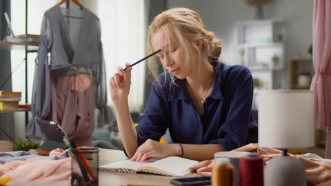 Young beautiful woman develops clothes design at home in living room 스톡 동영상 138811382