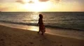 Young Beautiful Woman in Dress Enjoying Sunset on the Beach. Slow Motion. HD Footage
