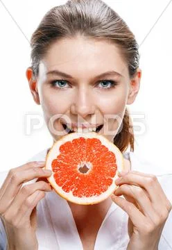 Young beautiful woman eat grapefruit isolated on white background Stock Photos