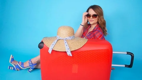Young beautiful woman in hat with suitcase Stock Footage