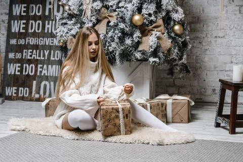 Young beautiful woman model with long hair in leggings long sweater christmas Stock Photos
