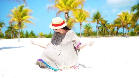 Young beautiful woman on tropical beach with palmtrees Stock Footage