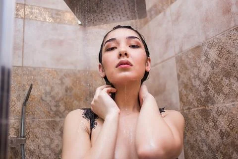 Young beautiful woman under shower Stock Photos