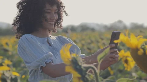 Young beautiful woman using camera to take sunflowers photo. Stock Footage 168374829