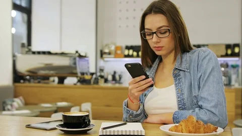 Young beautiful woman using mobile phone, texting massege, sending sms while Stock Footage 72361463