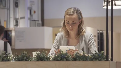 Young, beautiful woman using tablet and drinking tea in the cafe Video stock 78981882