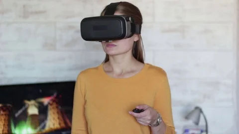 Young beautiful woman using virtual reality glasses Stock Footage 70716258
