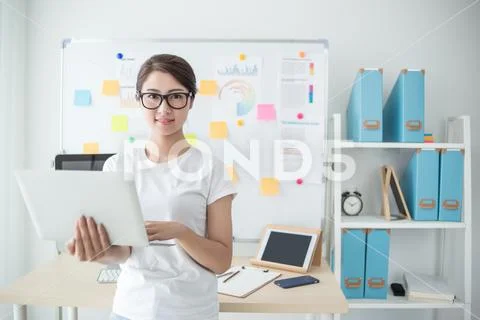Young beautiful woman working in the office Stock Photos