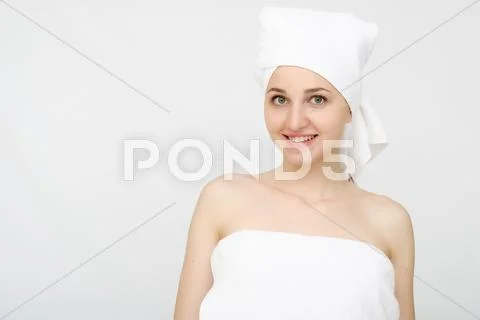 Young beautiful woman wrapped in towel Stock Photos