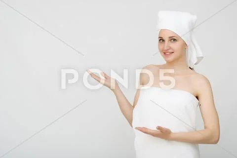 Young beautiful woman wrapped in towel Stock Photos