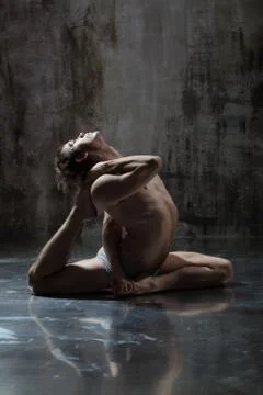 Young beautiful yoga instructor is posing in studio. Stock Photos