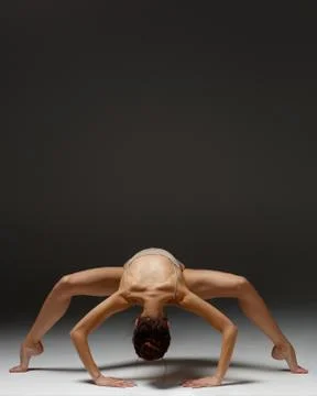 Young beautiful yoga instructor is posing in studio. Stock Photos