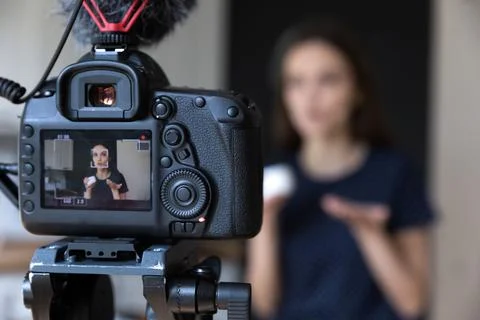 Young beauty blogger girl recording video on dslr camera Stock Photos