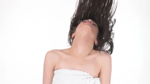 Young beauty woman throwing back head and tossing long wet hair in slow motion Stock Footage 131120853