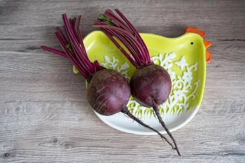 Young beetroot on the chicken shaped plate Stock Photos