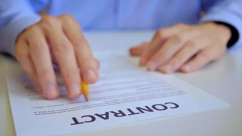 Young Beginning Entrepreneur Is Reading Contract During Working Day In Office Stock Footage 119355836
