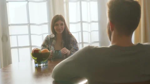 Young beloved couple sit at table chatting at home Stock Footage 266810602