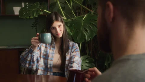 Young beloved couple sit at table chatting at home Video stock 266811289