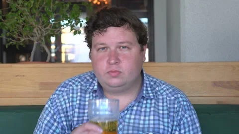 Young big man drinking a beer in restaurant or bar Stock Footage 95607507