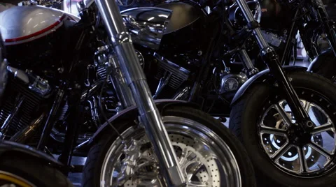Young biker chick standing among bespoke motorbikes Stock Footage 63027778
