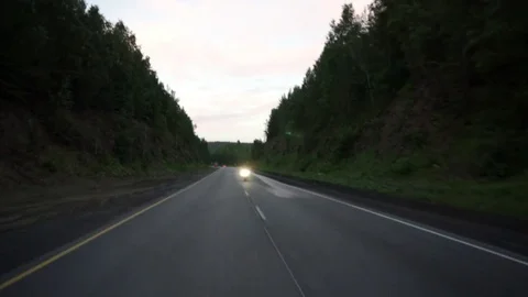 A young biker in a leather jacket and a helmet riding at the motorcycle along Stock Footage 83548870