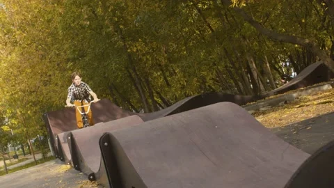 Young biker on the pump track Stock Footage 143790682