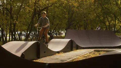 Young biker on the pump track Stock Footage 143790988