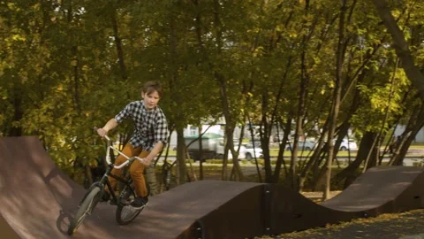 Young biker on the pump track Stock Footage 143791035