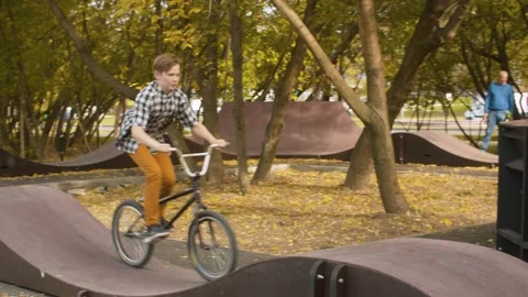 Young biker on the pump track Stock Footage 143792006
