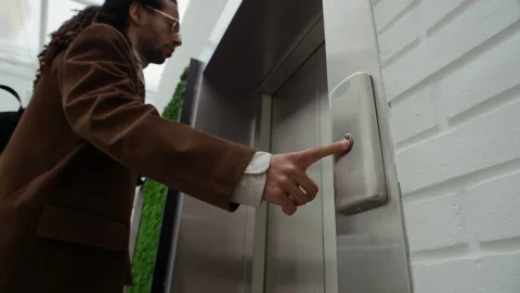 Young Biracial Businessman Pressing Elevator Button in Modern Office Building Stock Footage 331795005