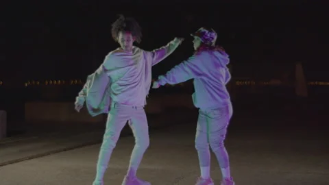 Young biracial couple dancing in city streets at night Stock-Footage 232425304