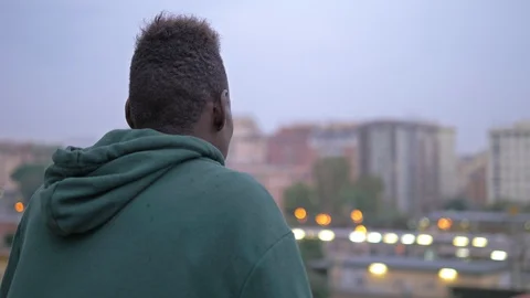 Young black african man contemplating the city- back view Stock Footage 101790460