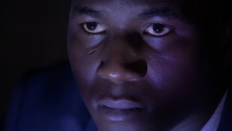 Young black african man watching tv alone in the dark Stock Footage 121448237