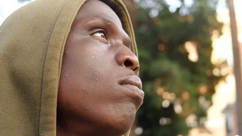 Young Black African migrant looking up, close up portrait Stock Footage 80681788