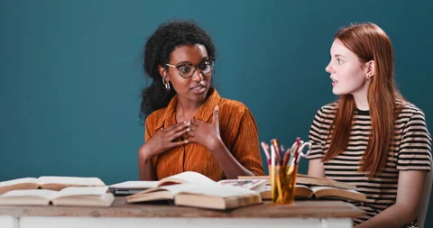 Young black and red haired woman discussing Stock Footage 134465750