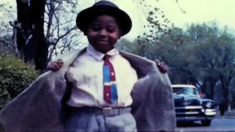 Young black boy is dressed for night on the town 1950s vintage home movie 4703 Stock Footage